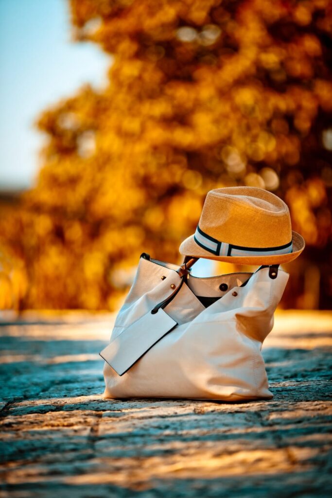 leather female bag and textile hat on street pavem 2023 11 27 04 51 23 utc